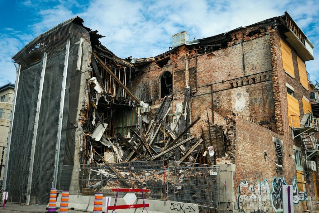 Scene of a partially demolished brick building in Montreal, showcasing urban decay and redevelopment.
