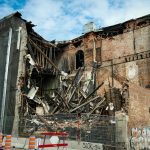 Scene of a partially demolished brick building in Montreal, showcasing urban decay and redevelopment.