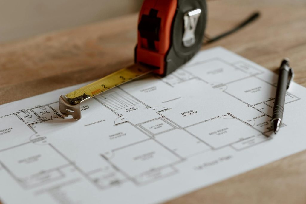 From above of ruler placed near pencil on engineering plan of house during renovation process inşaat metraj