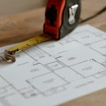 From above of ruler placed near pencil on engineering plan of house during renovation process inşaat metraj