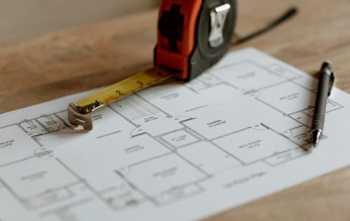 From above of ruler placed near pencil on engineering plan of house during renovation process inşaat metraj