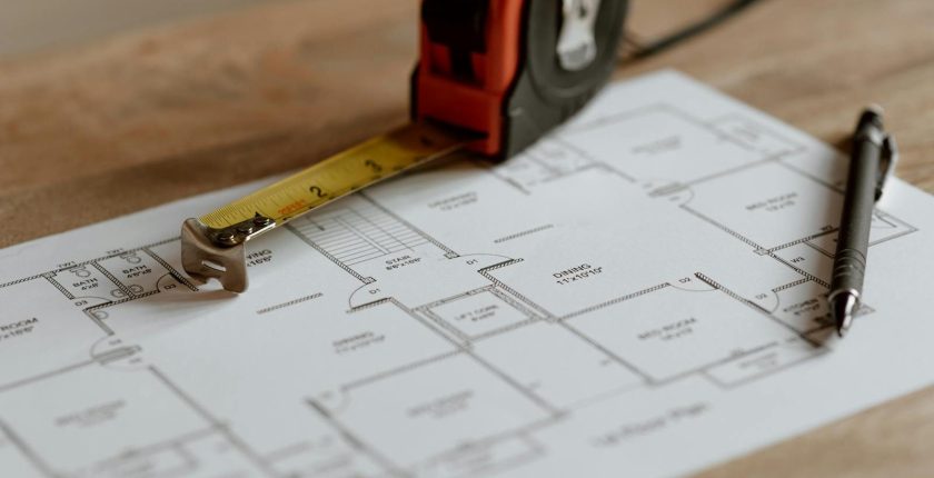From above of ruler placed near pencil on engineering plan of house during renovation process inşaat metraj