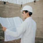 Architect examining blueprints at a construction site in Mexico.