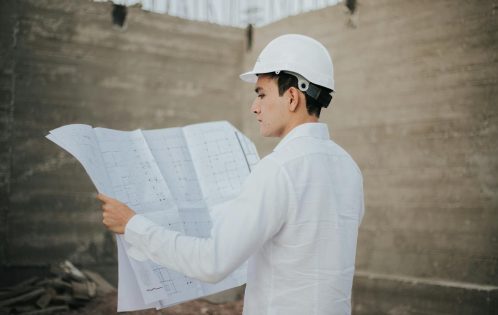 Architect examining blueprints at a construction site in Mexico.